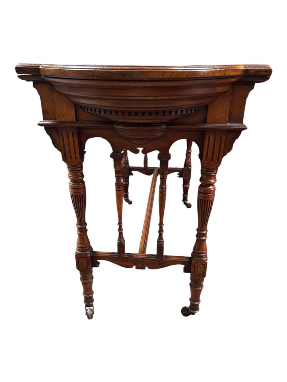 An antique warm brown oak library table featuring turned fluted legs, vertical spindle stretchers, and a polished rectangular top with rounded edges. View VII