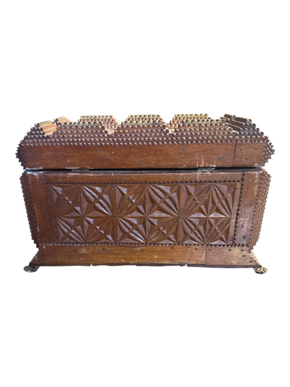 A Victorian tramp art wooden box featuring chip-carved pyramid layers, glass inserts, a metal lion head pull, and small metal feet. View VI