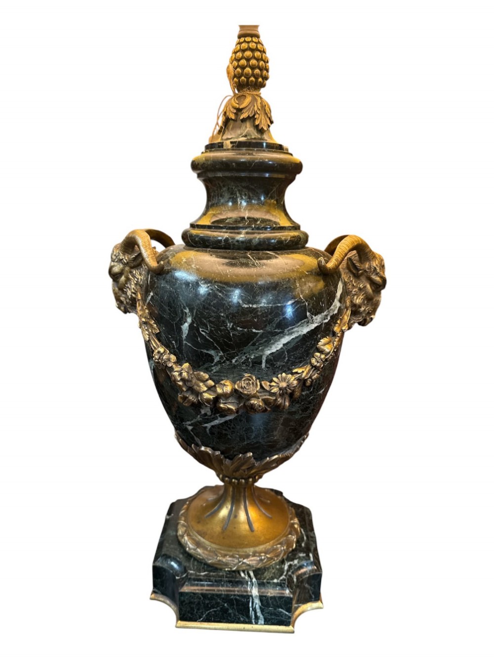A pair of 19th-century French table lamps crafted from dark veined marble in urn shapes with gilt metal mounts and amber fabric shades featuring fringe trim. View IV