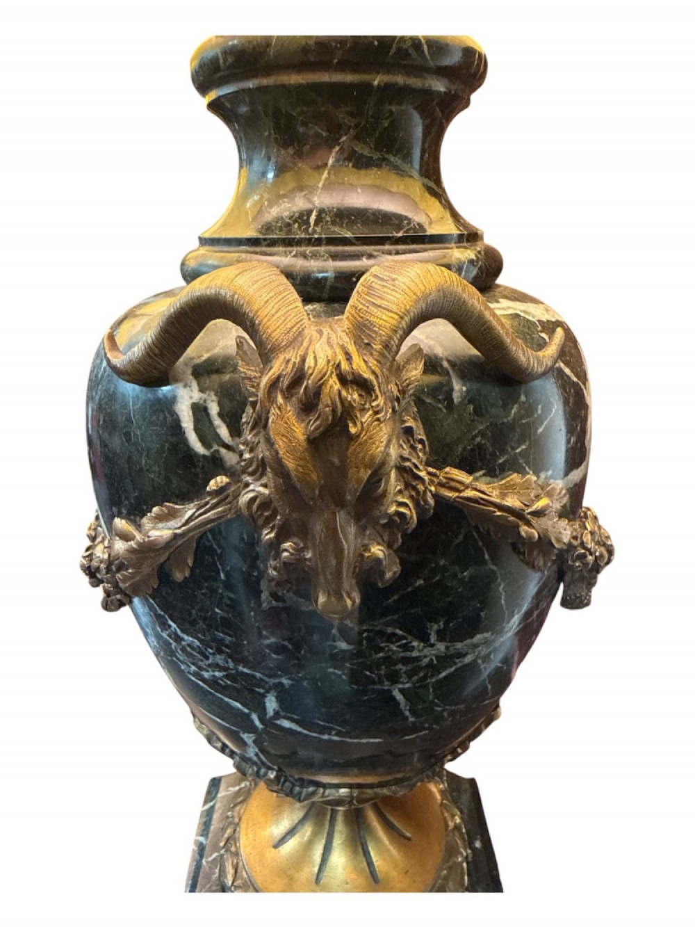 A pair of 19th-century French table lamps crafted from dark veined marble in urn shapes with gilt metal mounts and amber fabric shades featuring fringe trim. View VI