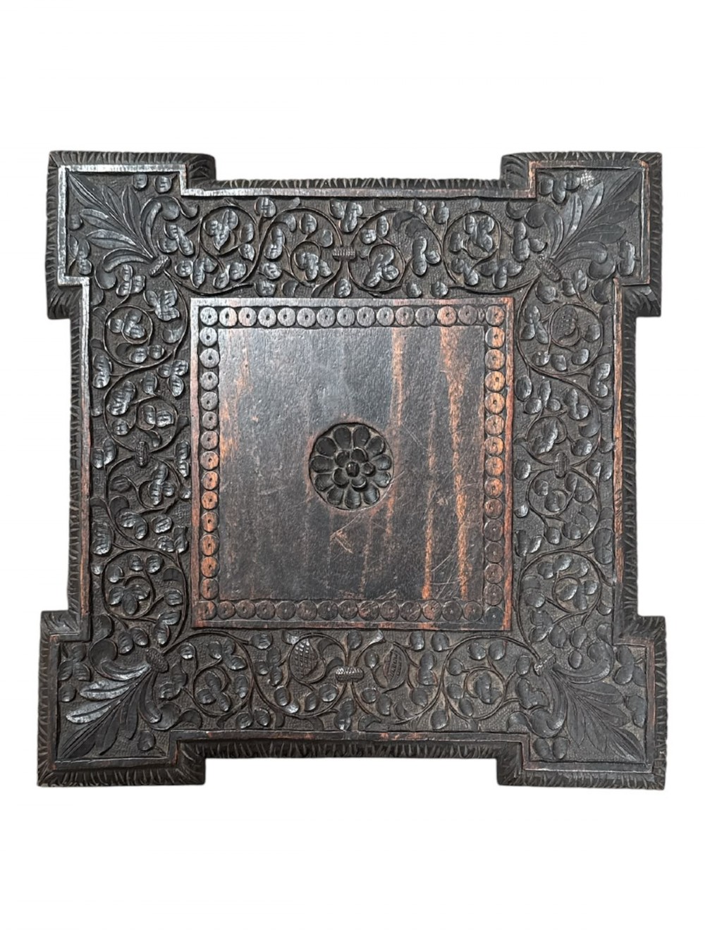 A 19th-century dark hardwood Anglo-Indian occasional table featuring intricately carved scale motifs on the legs, a carved undertier shelf, and a textured top. View II