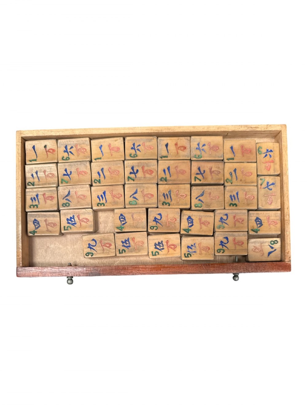 An antique warm brown wooden cabinet featuring a metal top handle, a removable front panel with red characters, and multiple drawers holding mahjong tiles and counting sticks. View III