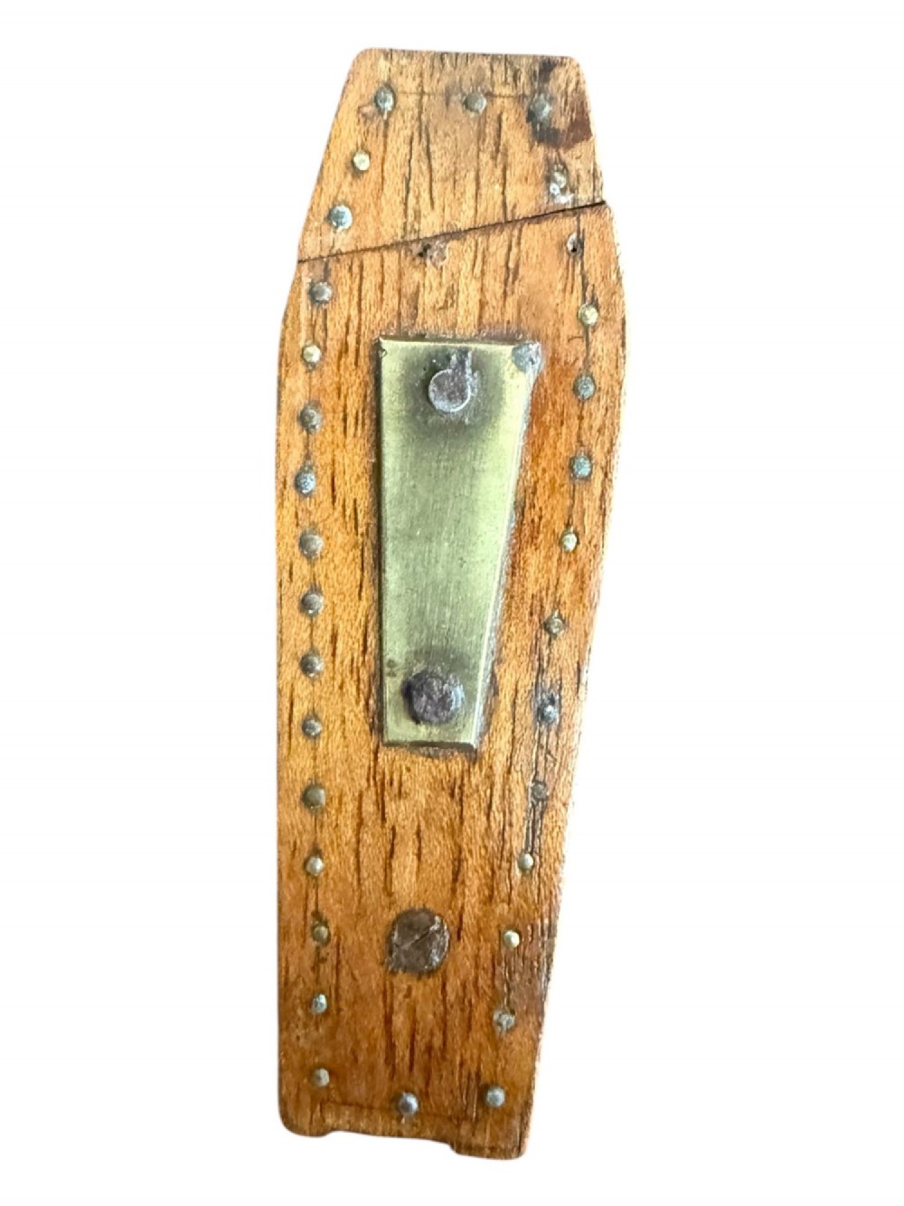 A coffin-shaped wooden puzzle snuff box decorated with a central brass plate and metal studs.