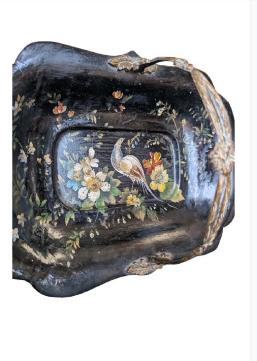 Victorian black lacquered papier-mache basket featuring hand-painted floral motifs, a bird illustration, a scalloped border, and a gilt metal swing handle. View IV