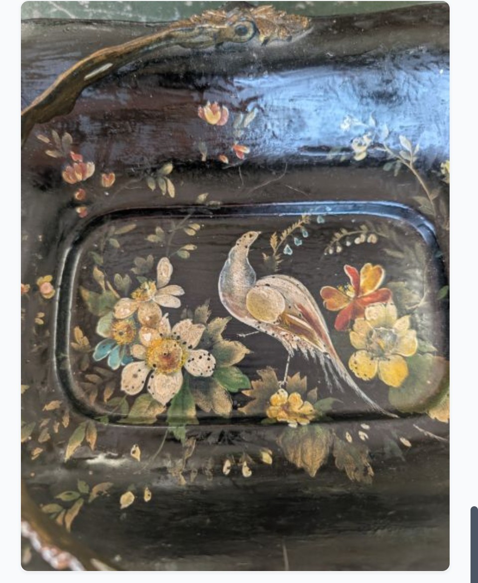 Victorian black lacquered papier-mache basket featuring hand-painted floral motifs, a bird illustration, a scalloped border, and a gilt metal swing handle. View VIII