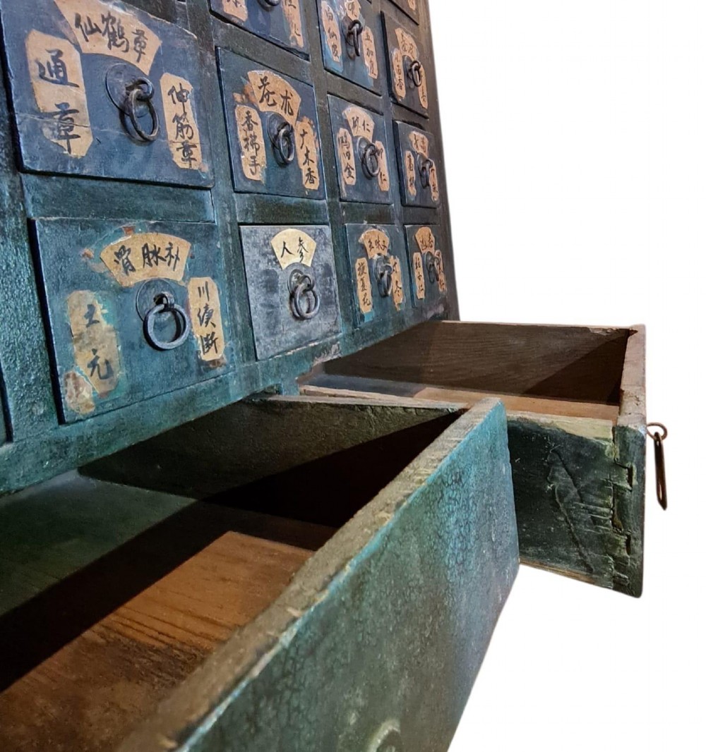 A tall dark elm Chinese apothecary chest featuring multiple small drawers inscribed with calligraphic characters above three larger base drawers. View VI