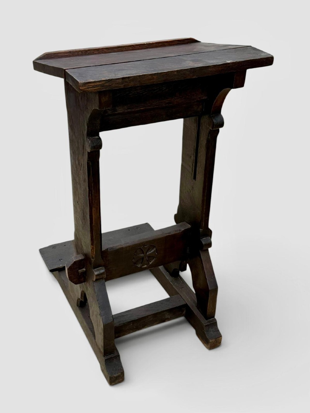 A dark oak antique prayer desk featuring a slanted bookrest shelf, carved gothic side supports, and a built-in kneeling platform. View V