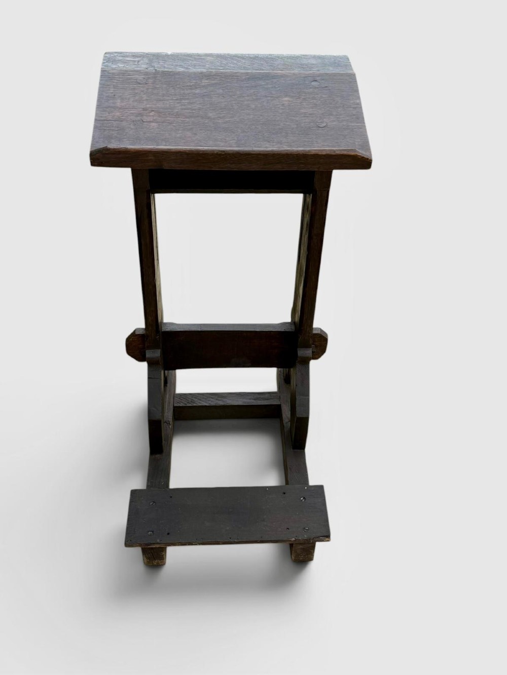 A dark oak antique prayer desk featuring a slanted bookrest shelf, carved gothic side supports, and a built-in kneeling platform. View VI