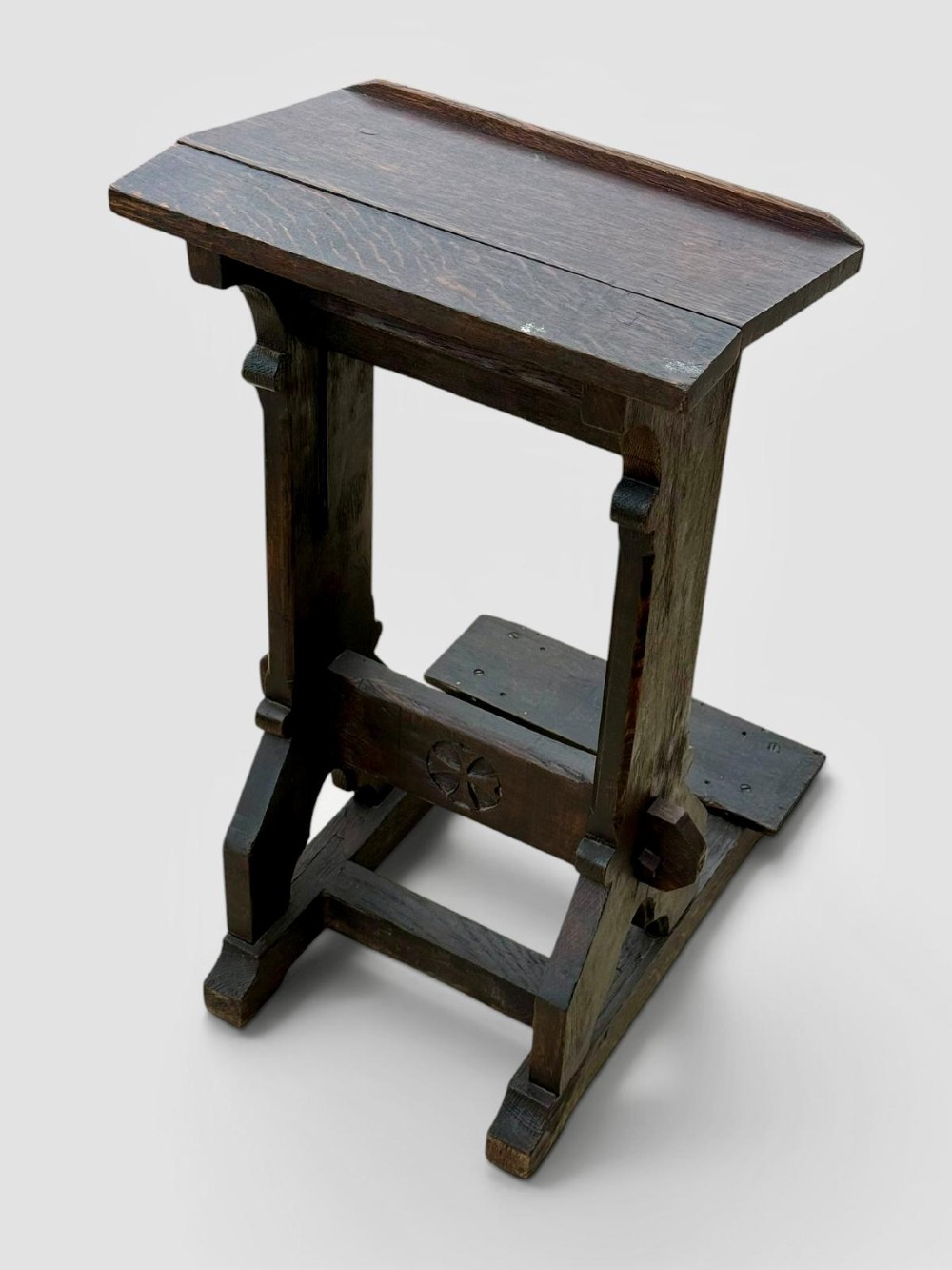 A dark oak antique prayer desk featuring a slanted bookrest shelf, carved gothic side supports, and a built-in kneeling platform. View VII