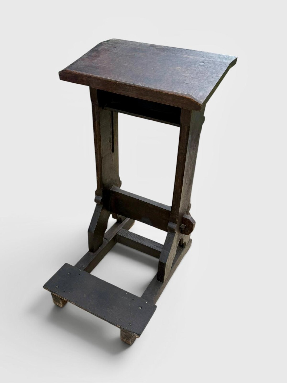 A dark oak antique prayer desk featuring a slanted bookrest shelf, carved gothic side supports, and a built-in kneeling platform. View IX