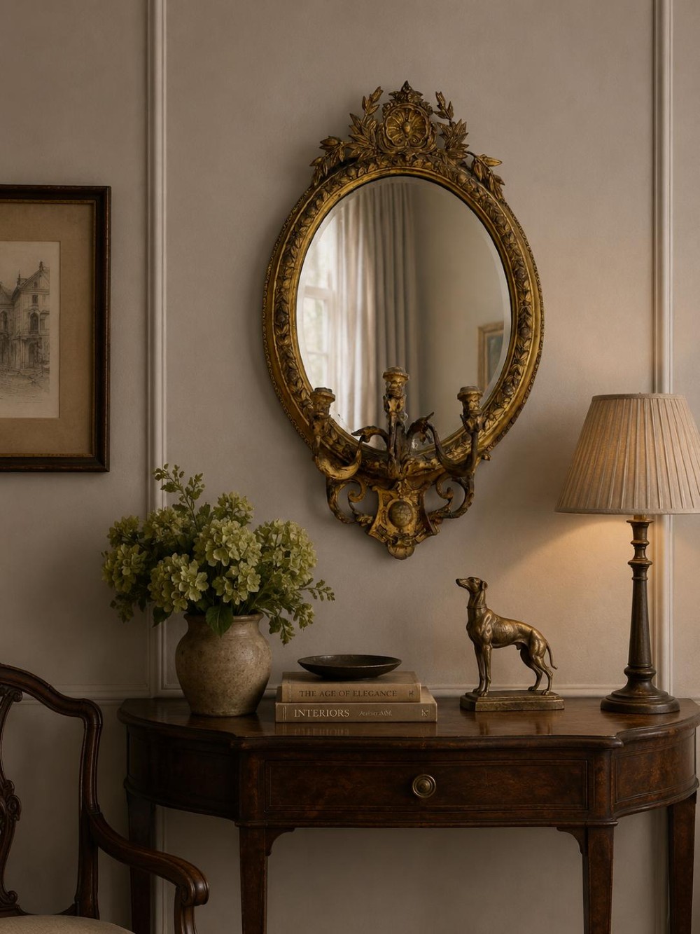 An oval Victorian giltwood and gesso girandole wall mirror featuring floral cresting, a beaded inner rim, and a three-branch candle sconce at the base. View XI