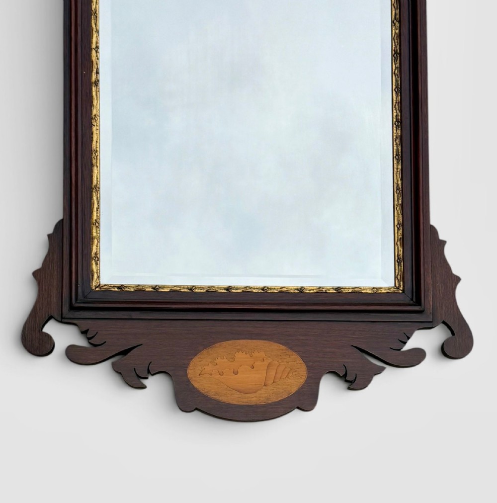 A rectangular Georgian style dark mahogany wall mirror featuring a gilded ho-ho bird crest, gilt inner slip border, and a carved shell marquetry medallion at the base. View II