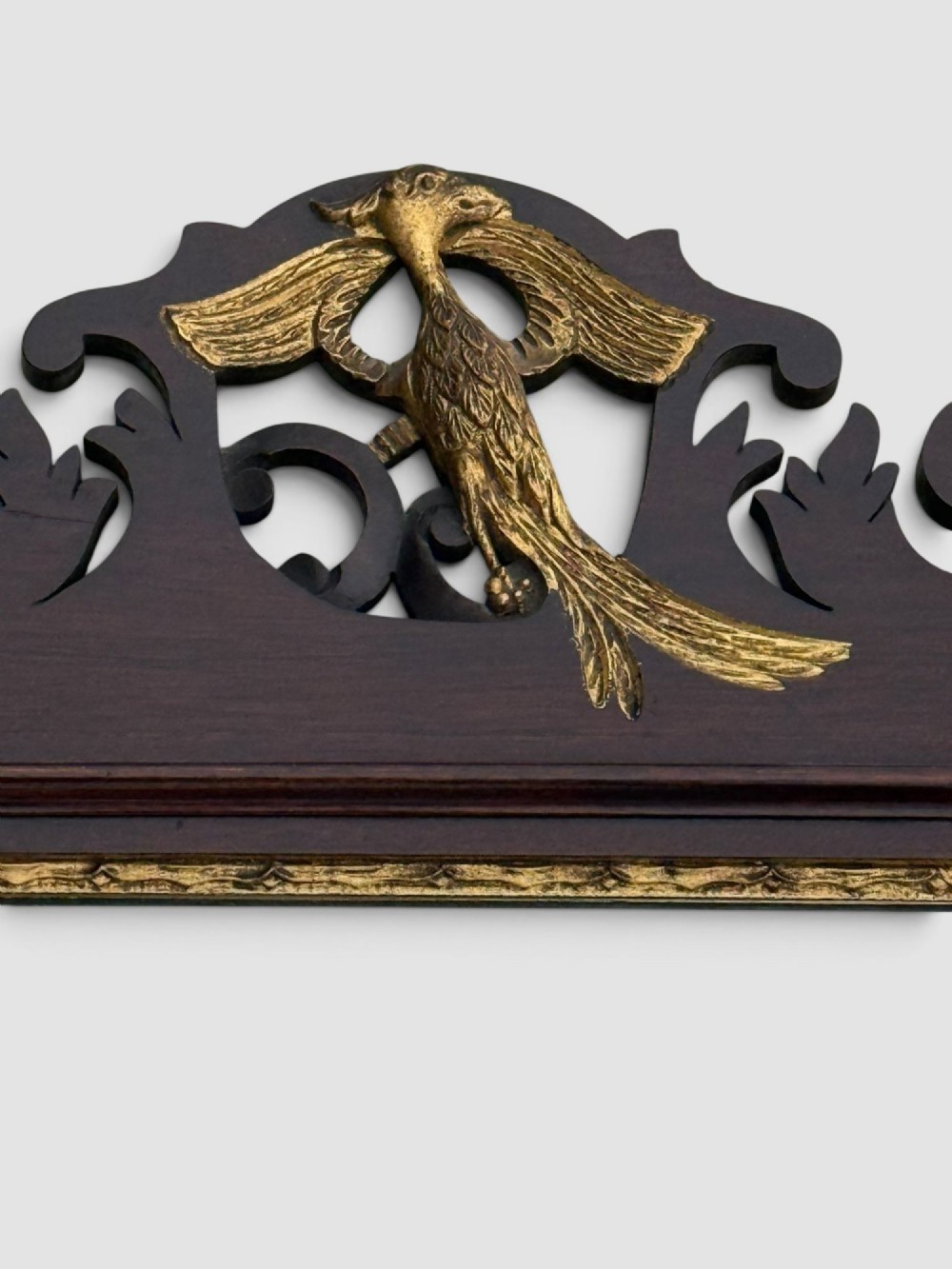 A rectangular Georgian style dark mahogany wall mirror featuring a gilded ho-ho bird crest, gilt inner slip border, and a carved shell marquetry medallion at the base. View V