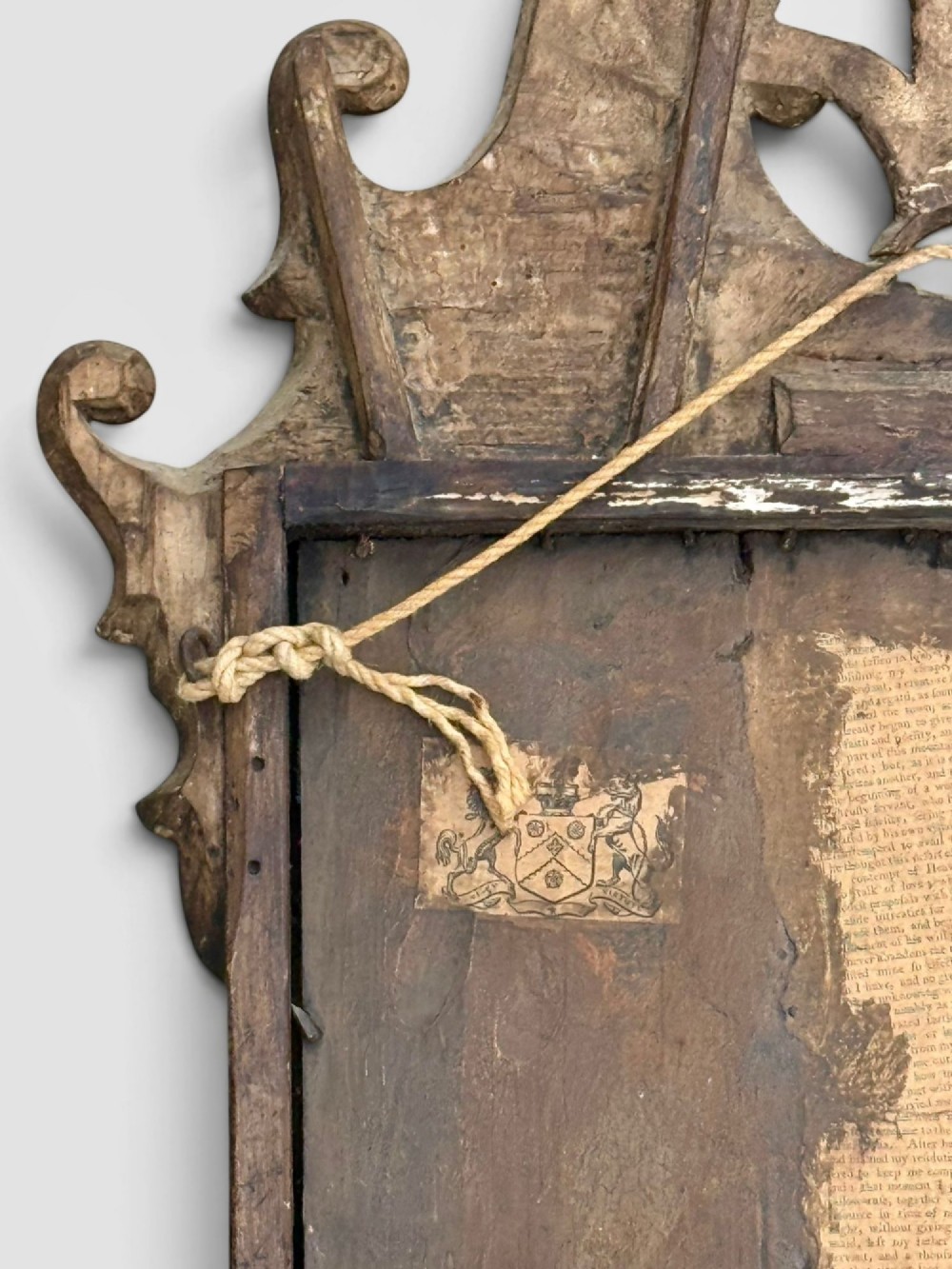 An 18th-century Georgian wall mirror featuring a carved walnut fretwork frame with a central gilded plume motif at the top. View V