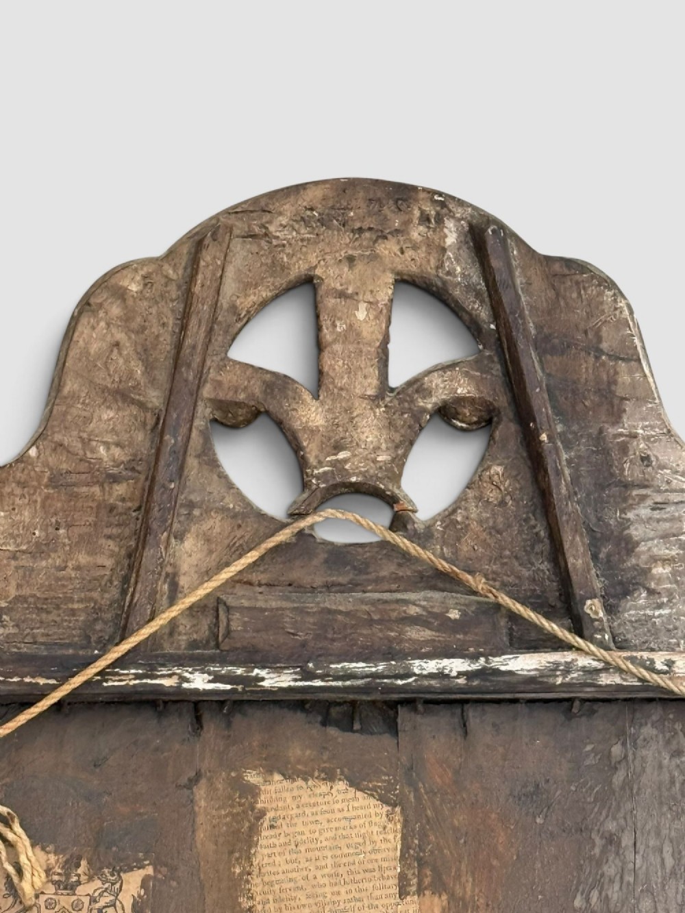 An 18th-century Georgian wall mirror featuring a carved walnut fretwork frame with a central gilded plume motif at the top. View VI