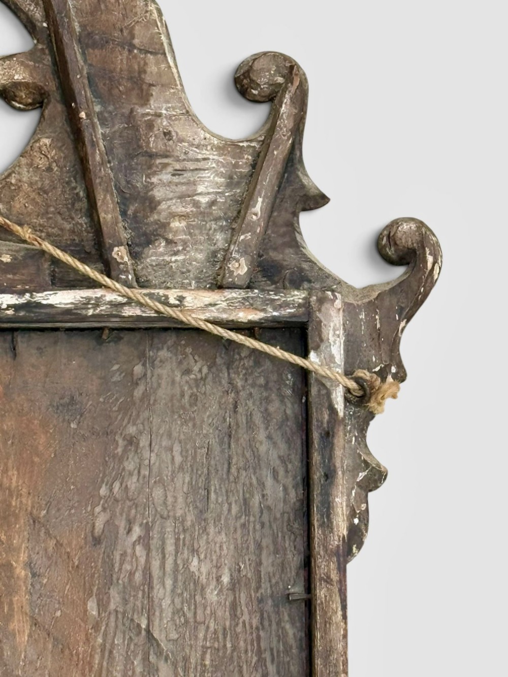 An 18th-century Georgian wall mirror featuring a carved walnut fretwork frame with a central gilded plume motif at the top. View IX