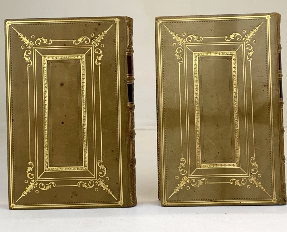 A two-volume set of 1848 leather-bound books titled Our Village, featuring elaborate gold tooling and raised spine bands. View XIII