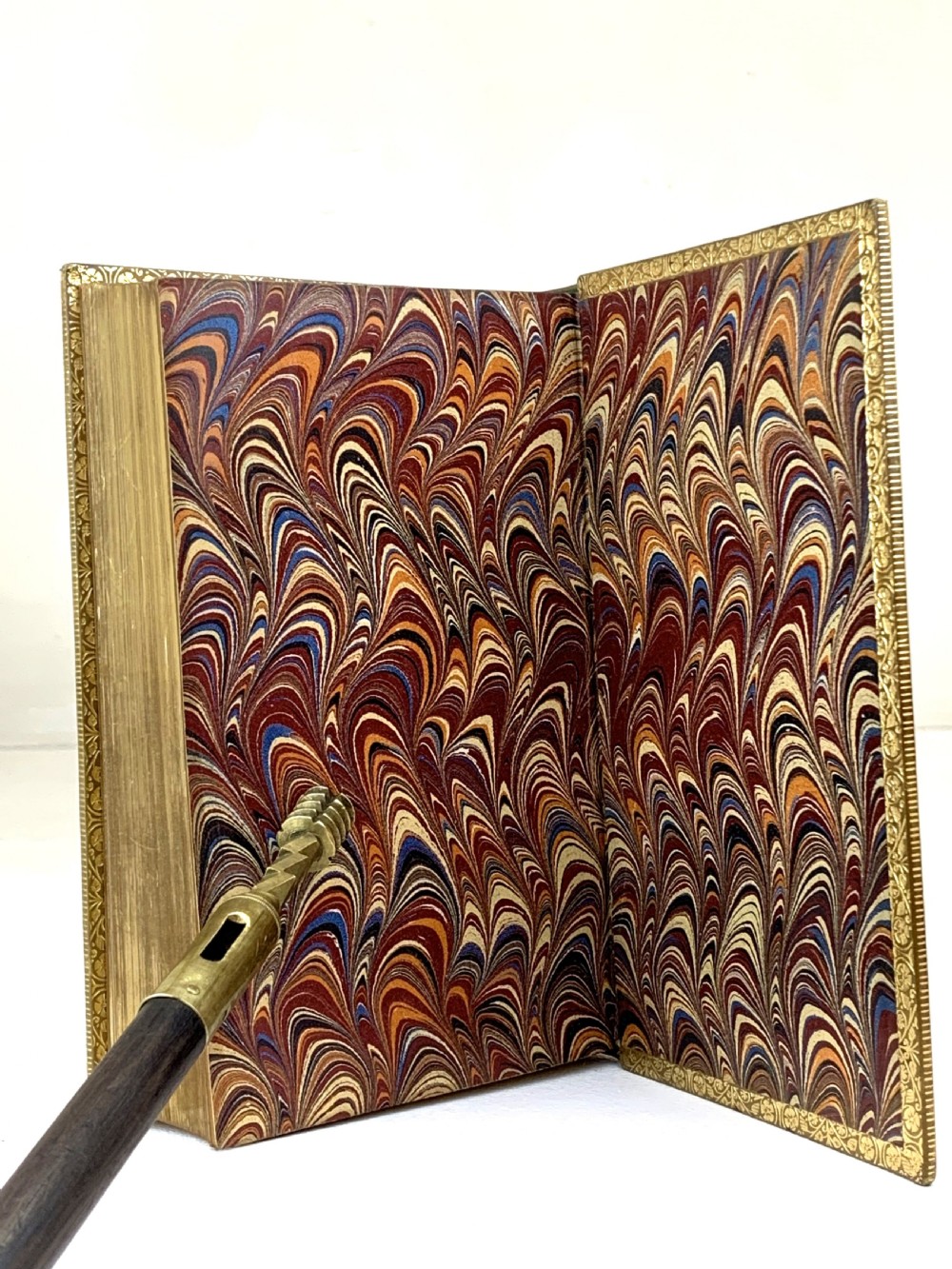 A two-volume set of 1848 leather-bound books titled Our Village, featuring elaborate gold tooling and raised spine bands. View XVIII