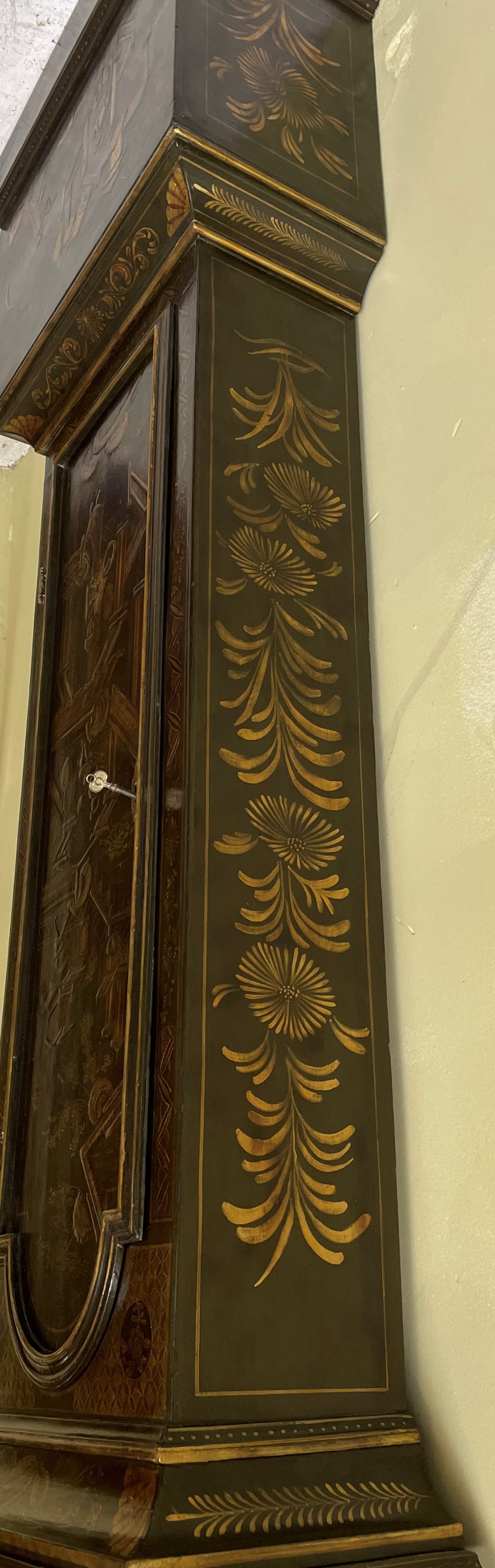An antique dark green japanned longcase clock featuring gilded chinoiserie landscape details, an arched hood with gold finials, and a brass dial with a Tempus Fugit boss. View IV
