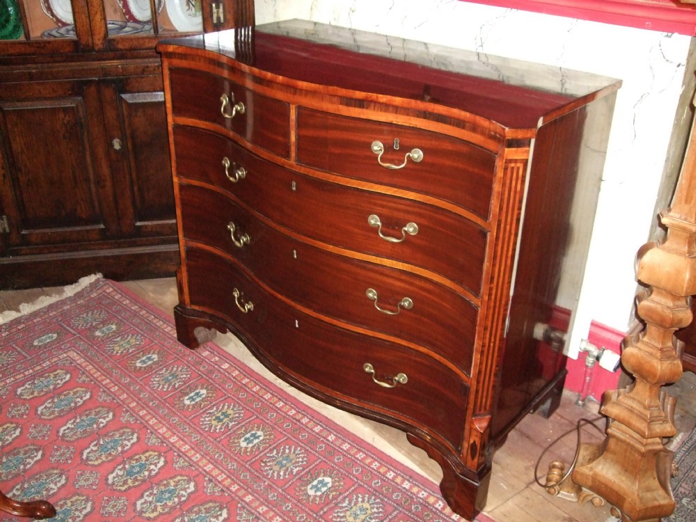 George 3rd Mahogany Serpentine Chest of Drawers with Satinwood Banding & Inlaid Features On Bracket Feet.