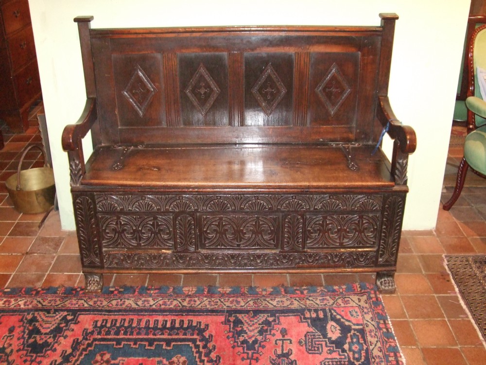 Late 18thC Oak Settle with Iron Strap Hinges & Carved Decoration.
