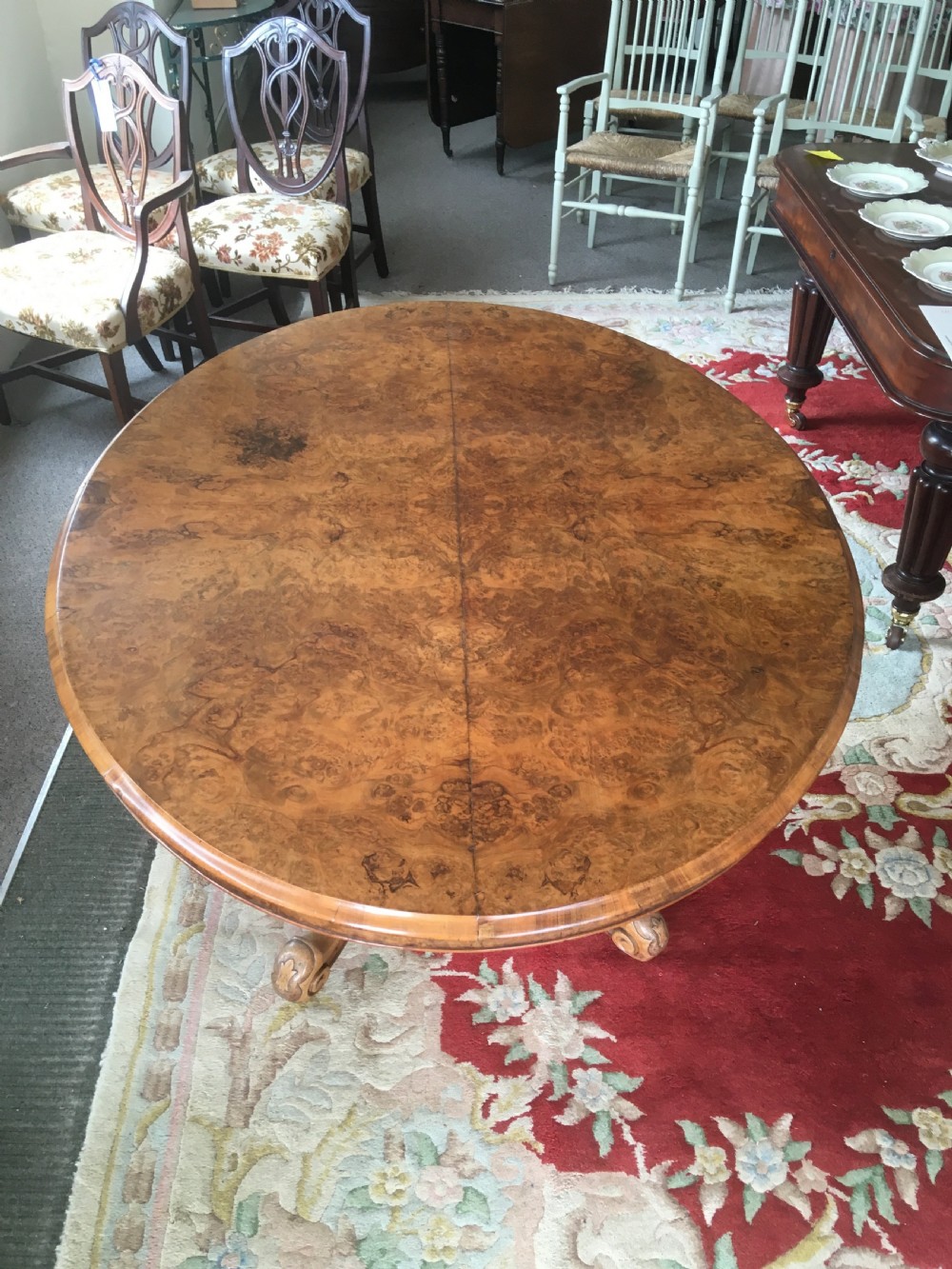 Victorian Burr Walnut Tilt-Top Dining/Centre Table on Carved Pedestal with Floral Decoration. View IV