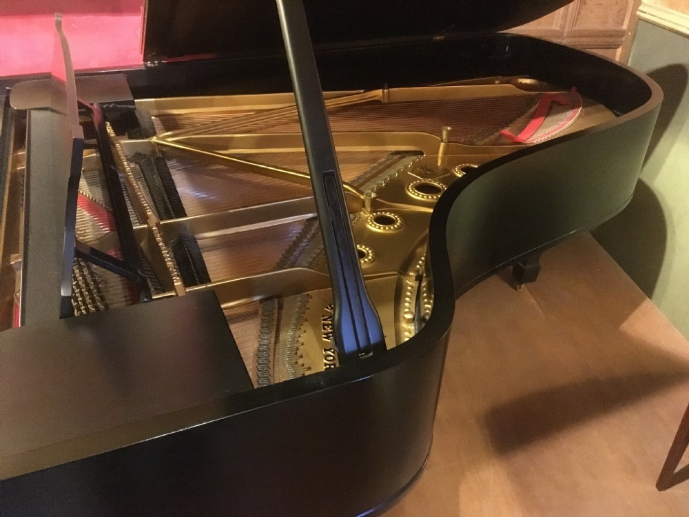 An ebonised black Steinway Model B grand piano with an open lid, full keyboard, and brass lyre pedal assembly. View II