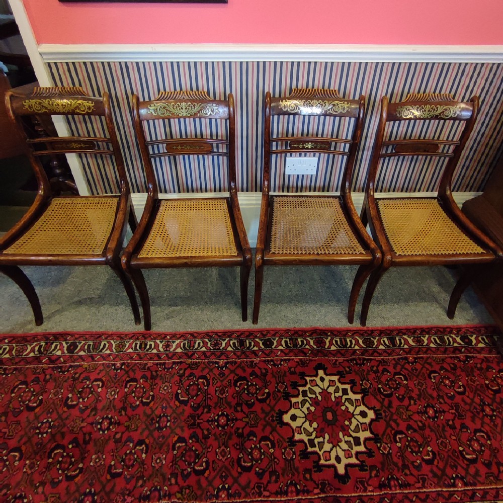 Set of Four Regency Brass Inlaid Rosewood Chairs with cane seats.