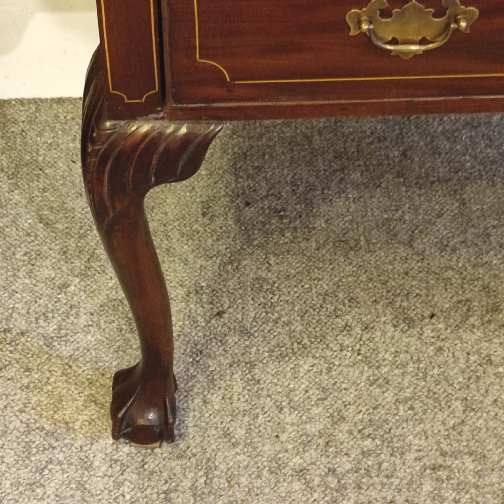 A 19th-century Philadelphia style mahogany chest on stand featuring a swan-neck pediment, fine line inlay, brass handles, and cabriole legs ending in ball-and-claw feet. View IV