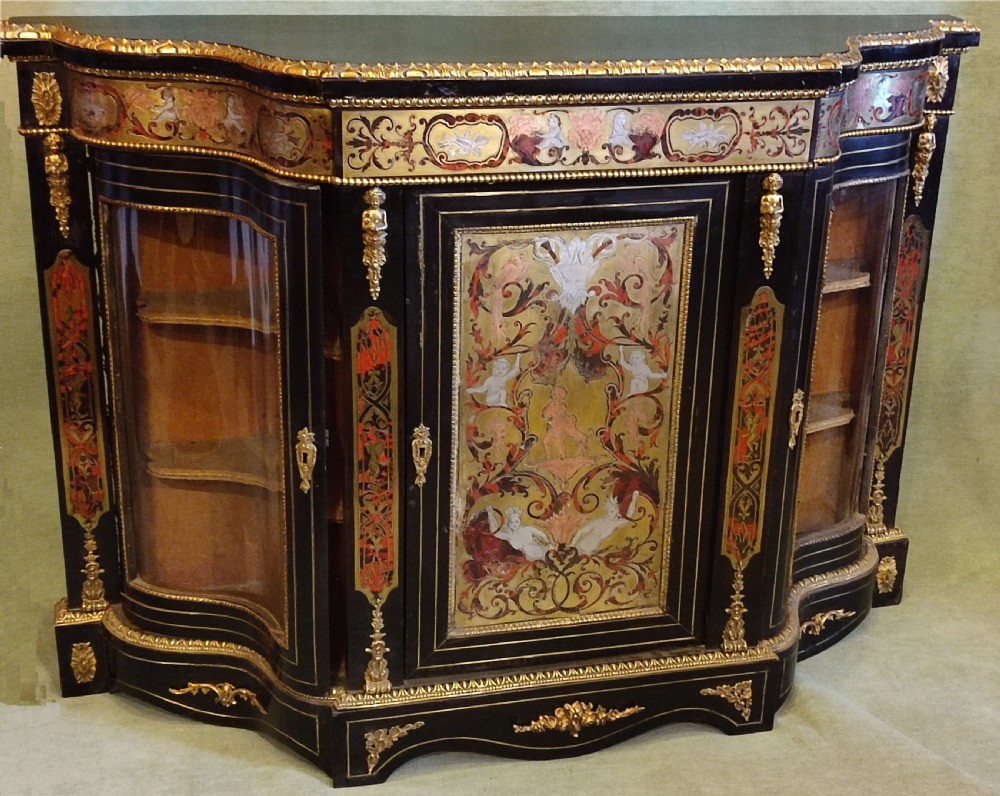 An ebonised 19th-century credenza featuring intricate brass and tortoiseshell Boulle marquetry, central panel with scrollwork, curved glazed side doors, and gilt bronze mounts.