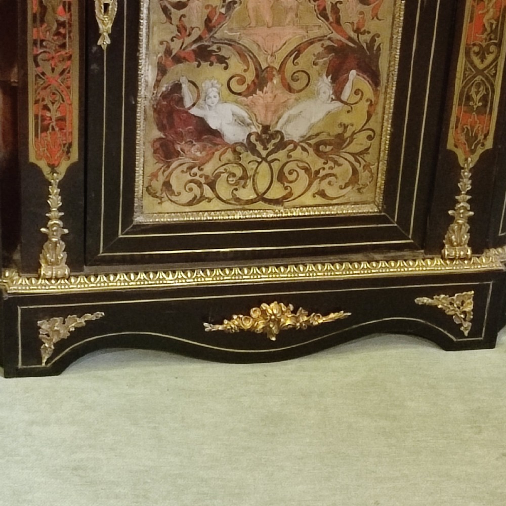An ebonised 19th-century credenza featuring intricate brass and tortoiseshell Boulle marquetry, central panel with scrollwork, curved glazed side doors, and gilt bronze mounts. View III