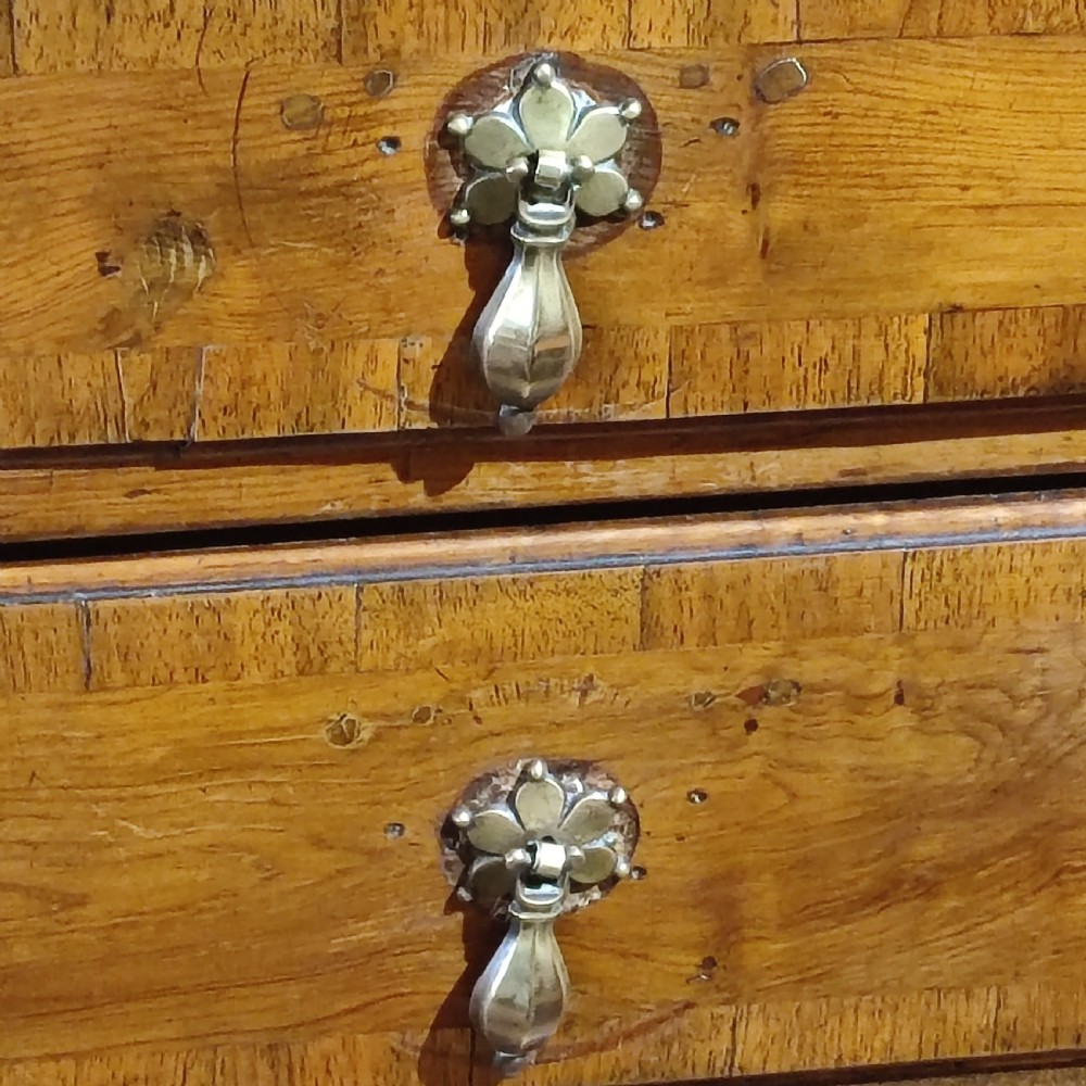 An antique Queen Anne yew wood chest on stand with crossbanded drawers, brass drop handles, and an arched apron raised on cabriole legs. View VI