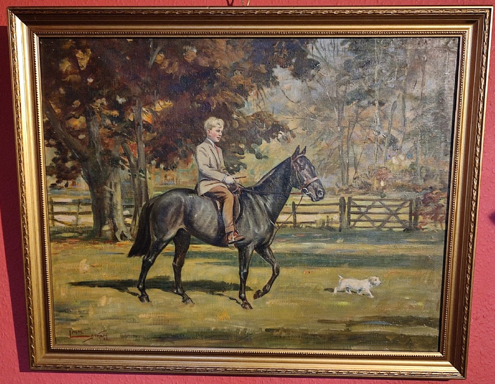Framed oil painting on canvas depicting a young boy in riding attire mounted on a dark horse, with a small dog alongside in a woodland setting.