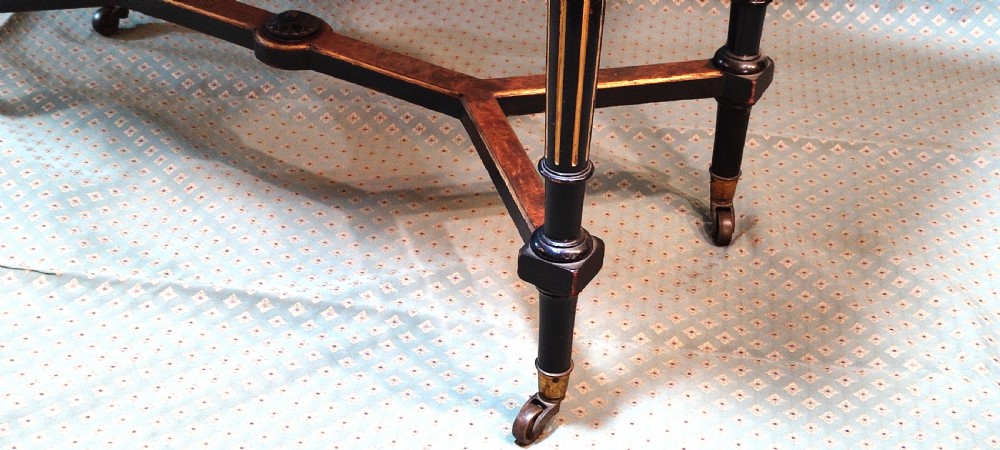 An antique amboyna and ebony card table featuring intricate wood grain and turned legs. View V
