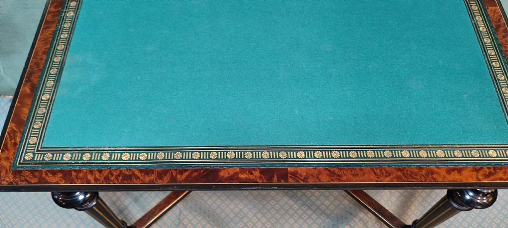 An antique amboyna and ebony card table featuring intricate wood grain and turned legs. View VI