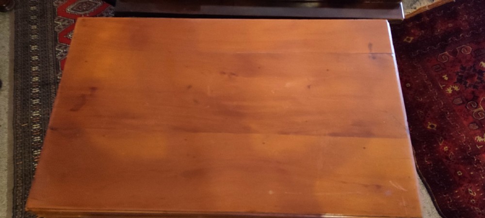 A rectangular yew wood kneehole desk featuring multiple drawers, a central recessed cupboard door, and brass drop handles. View IV