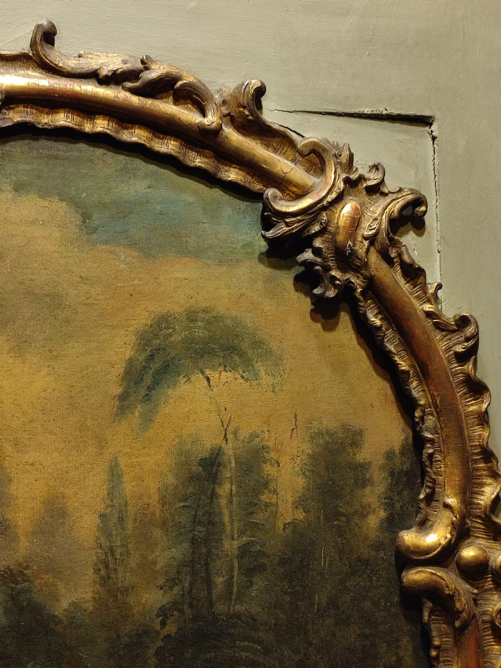 A large nineteenth-century French trumeau mirror featuring a painted canvas of a romantic pastoral scene above a mirror glass, set within carved giltwood frames on a grey painted panel. View III