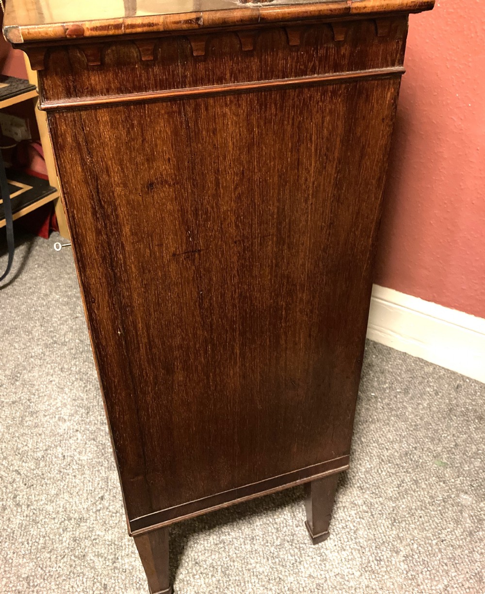 A Regency mahogany side cabinet featuring an upper gallery shelf on turned supports, two drawers, oval-inlaid cupboard doors, and tapered square legs. View II