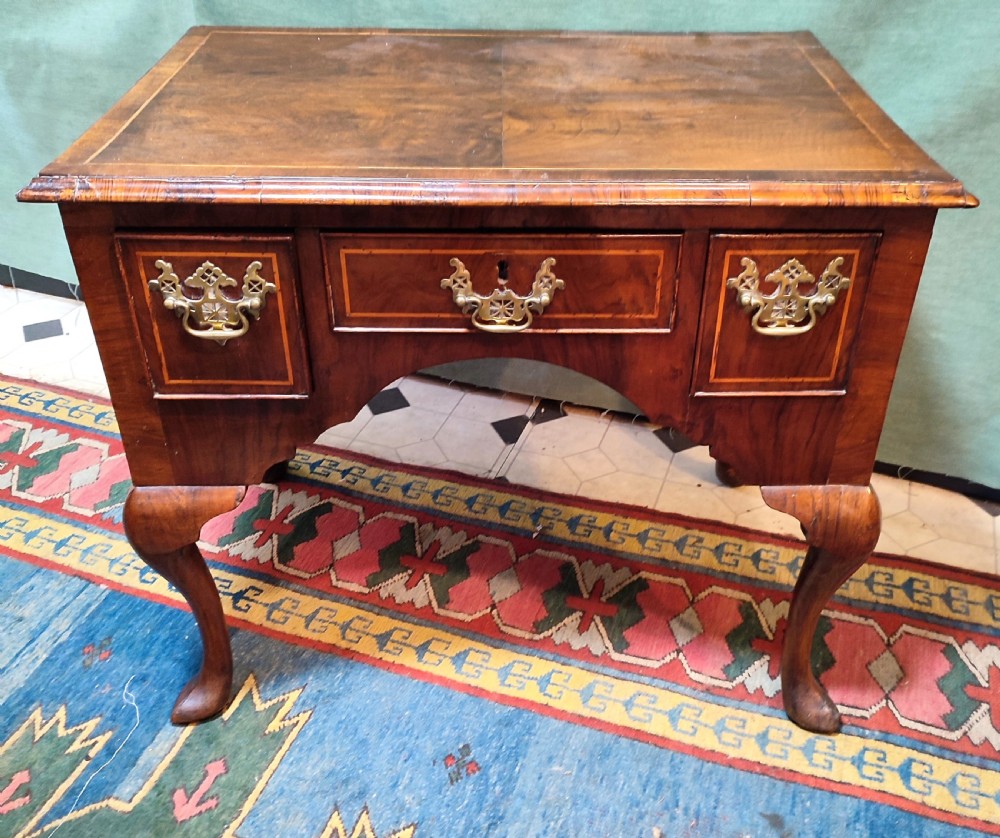 An 18th-century George III walnut lowboy table featuring three inlaid drawers, brass handles, a shaped apron, and four cabriole legs. View II