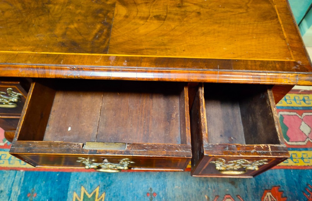 An 18th-century George III walnut lowboy table featuring three inlaid drawers, brass handles, a shaped apron, and four cabriole legs. View IV
