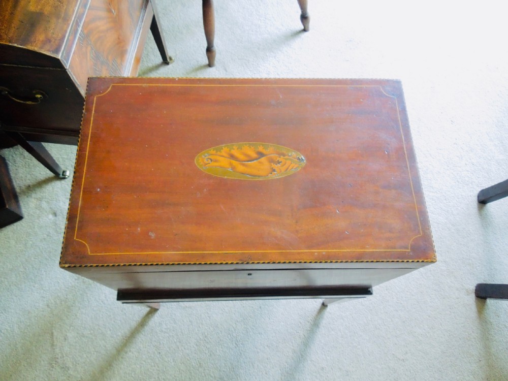 A Georgian mahogany wine cooler on square tapered legs featuring fine boxwood stringing and a central shell inlay medallion. View III