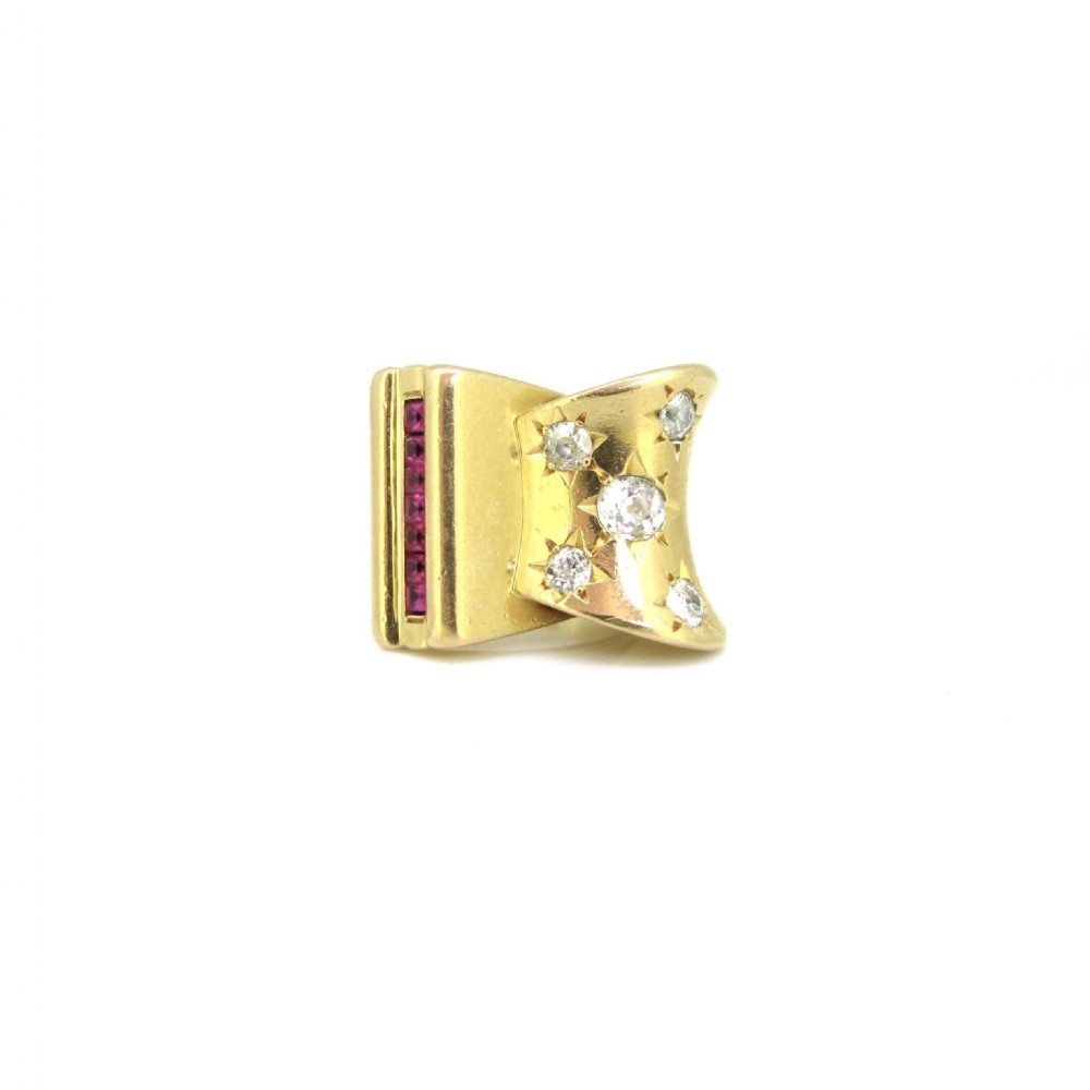 An 18ct yellow gold 1940s Retro Tank ring featuring a sculptural scroll motif set with diamonds and channel-set red rubies. View II
