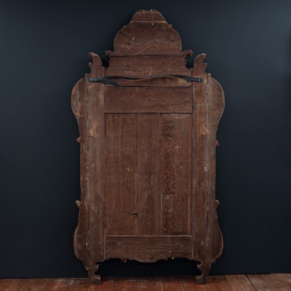 An ornate Louis XV style gilded mirror featuring a carved timber frame with vine motifs and a flower basket crest. View XII
