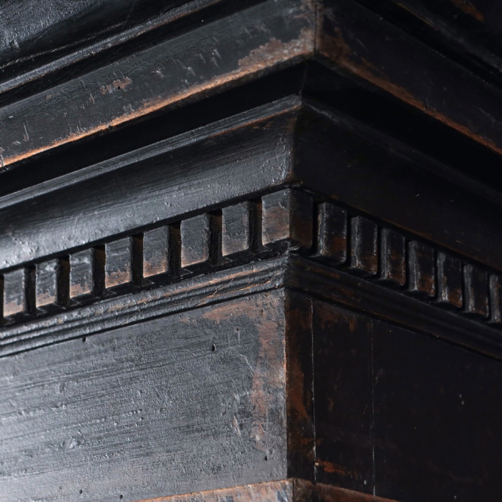 An 18th-century Tuscan cabinet featuring a distressed black painted finish, moulded cornice, panelled double doors, and lower drawers on bracket feet. View XIII