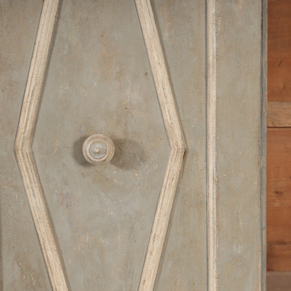 A nineteenth-century Italian painted timber cupboard featuring double doors with raised diamond panel mouldings and a muted grey finish. View III
