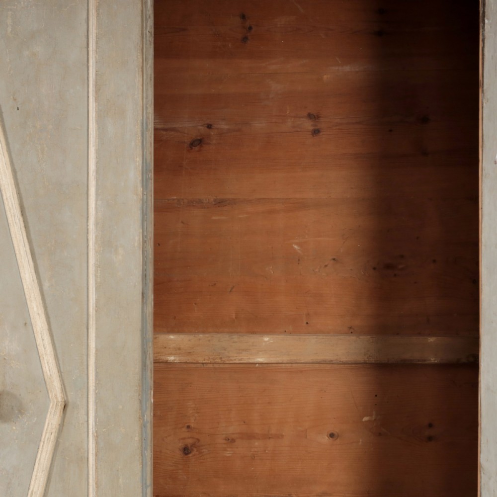A nineteenth-century Italian painted timber cupboard featuring double doors with raised diamond panel mouldings and a muted grey finish. View IV