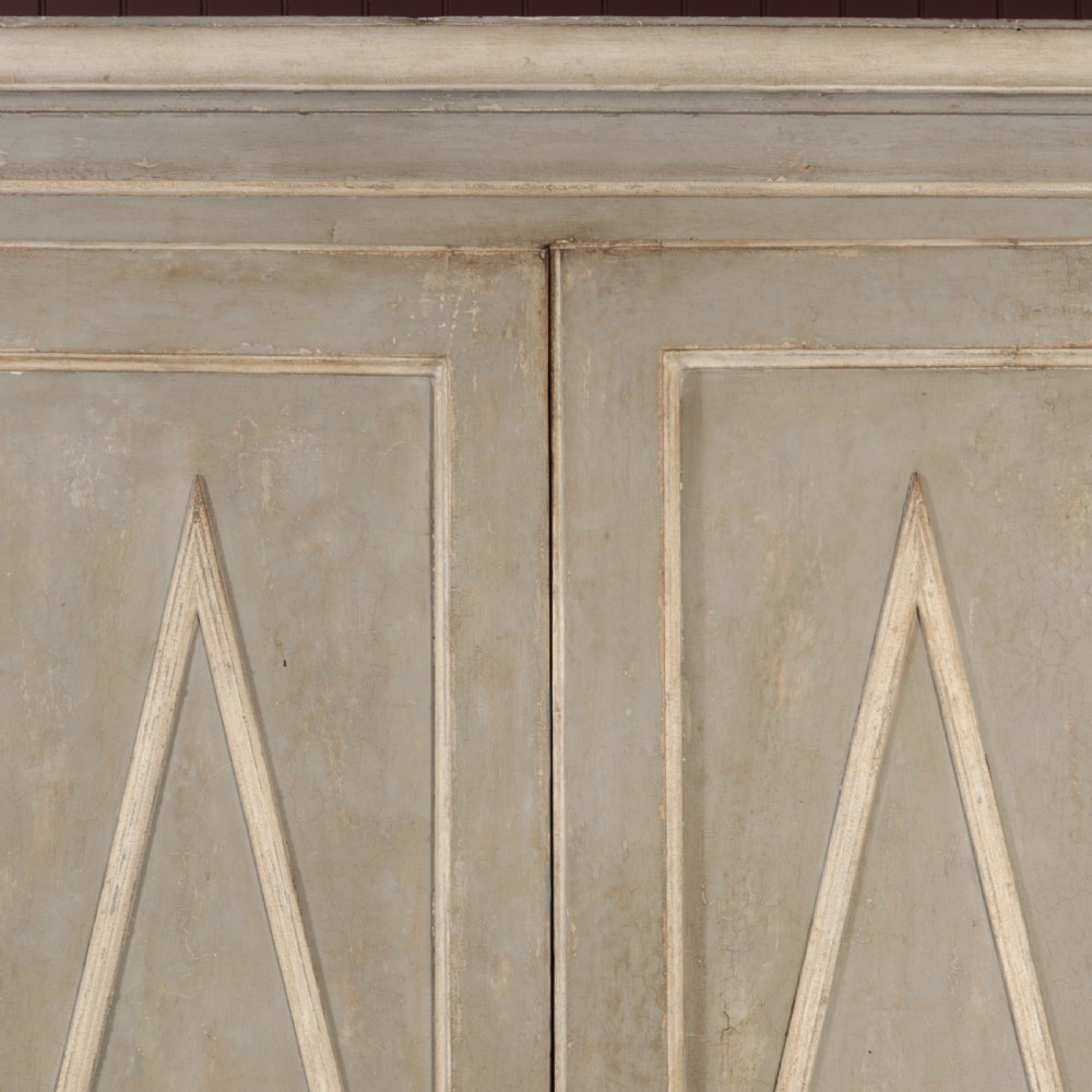 A nineteenth-century Italian painted timber cupboard featuring double doors with raised diamond panel mouldings and a muted grey finish. View X