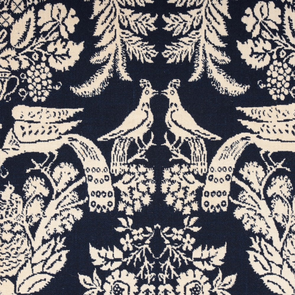 A nineteenth-century woven Jacquard coverlet in navy blue and cream featuring repeating floral urns, birds, and an architectural border with fringe. View V