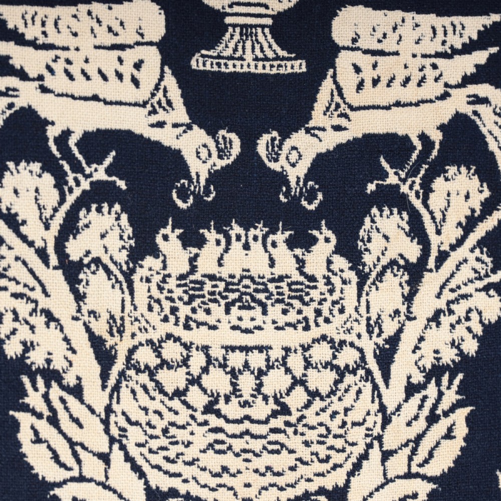 A nineteenth-century woven Jacquard coverlet in navy blue and cream featuring repeating floral urns, birds, and an architectural border with fringe. View X
