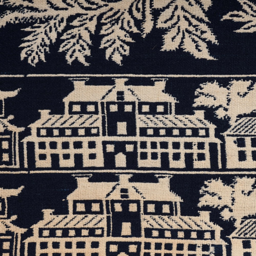 A nineteenth-century woven Jacquard coverlet in navy blue and cream featuring repeating floral urns, birds, and an architectural border with fringe. View XI
